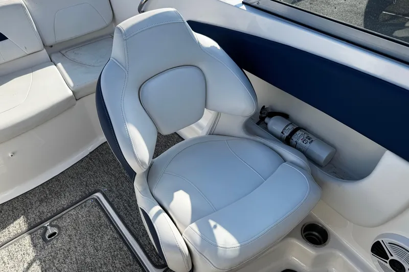 Slide: The Image of 2015 Chaparral 19 H2O Sport boat interior with gray seating and fire extinguisher. - 44