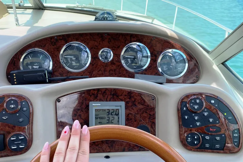 Slide: The Image of 2003 Sea Ray Sundancer 320 yacht docked in a marina under clear blue skies. - 3