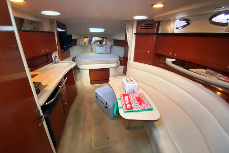 Slide: The Image of 2003 Sea Ray Sundancer 320 yacht docked at marina, evening setting. - 4