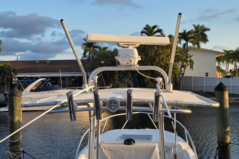 Slide: The Image of 2000 SeaVee 290B boat docked, featuring radar equipment and fishing rod holders. - 11