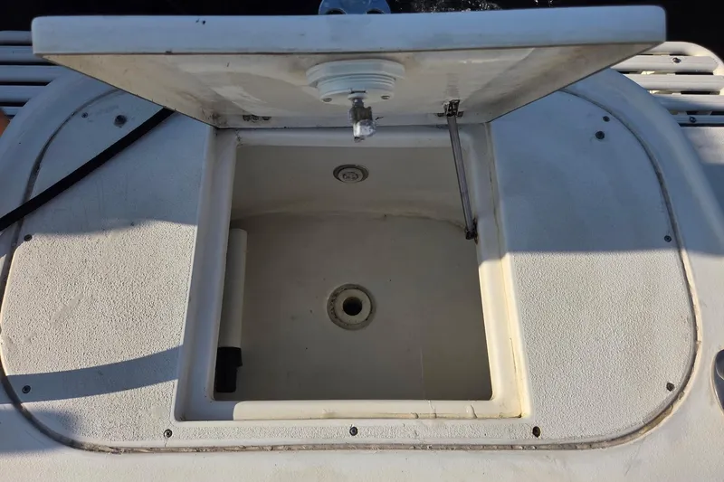 Slide: The Image of Open storage compartment on a 2000 SeaVee 290B boat, showcasing interior details. - 12