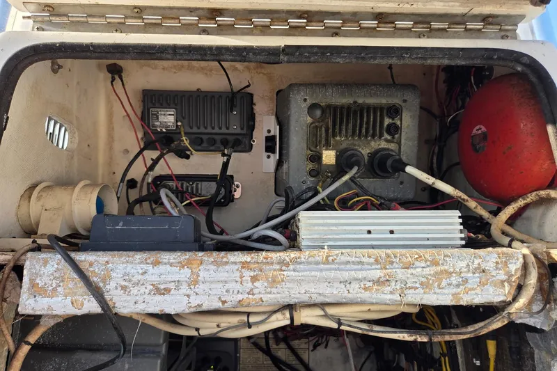 Slide: The Image of Electrical components inside a 2000 SeaVee 290B boat, featuring wiring and equipment. - 19