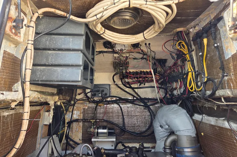 Slide: The Image of Engine compartment of a 2000 SeaVee 290B boat, showcasing wiring and mechanical components. - 21