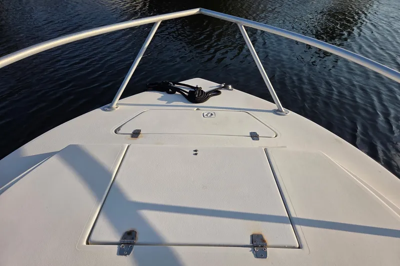 Slide: The Image of Bow view of 2000 SeaVee 290B boat with railing and storage compartments. - 24