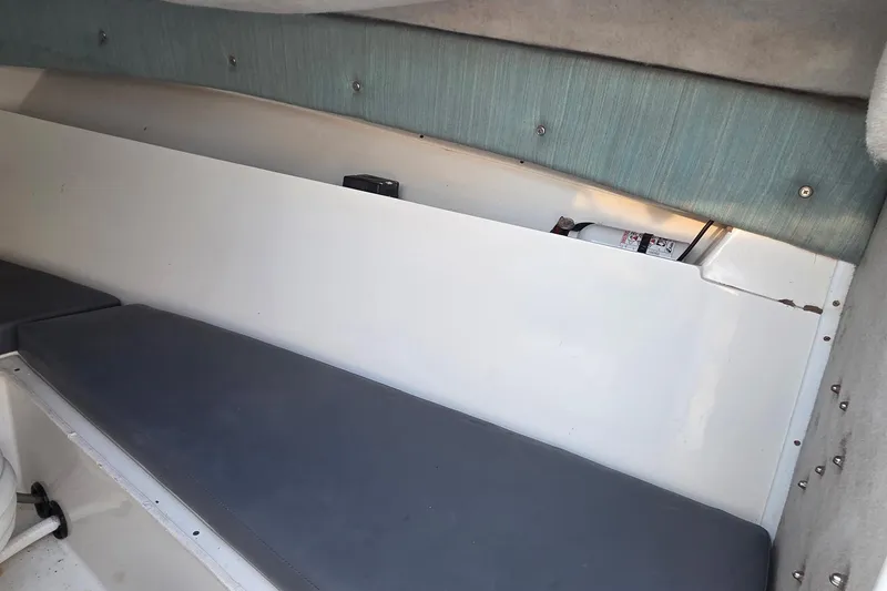 Slide: The Image of Interior cabin of 2000 SeaVee 290B boat with cushioned seating and storage. - 28