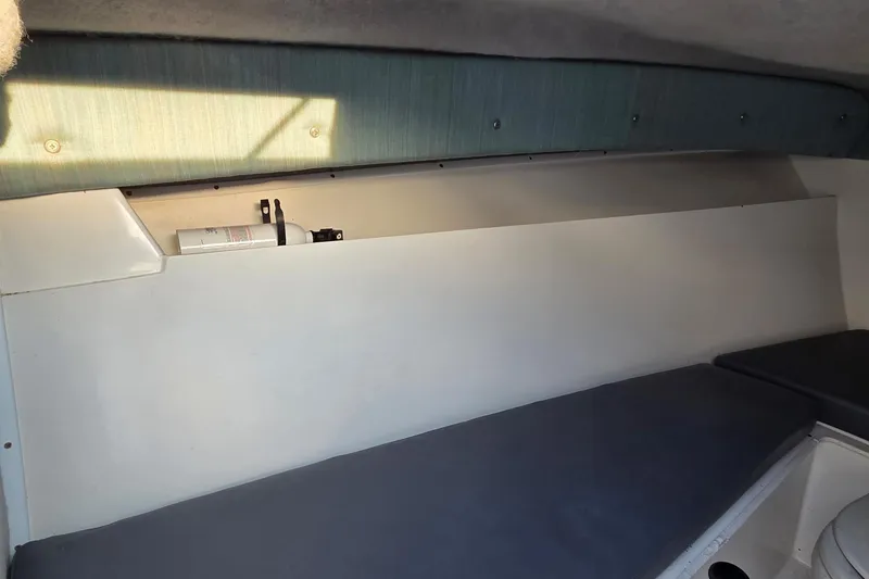 Slide: The Image of Interior cabin of 2000 SeaVee 290B boat with seating and storage area. - 29
