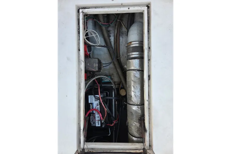 Slide: The Image of Engine compartment of a 2000 SeaVee 290B boat, showing battery and wiring. - 30
