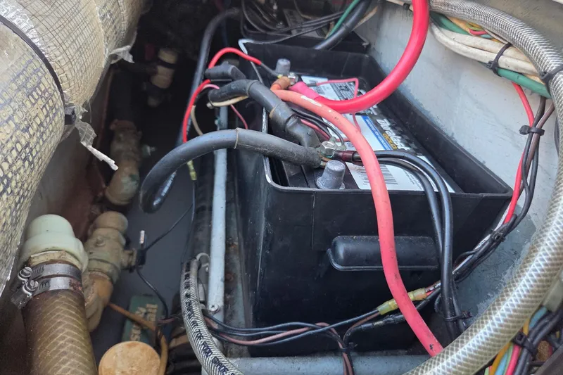 Slide: The Image of Battery compartment of a 2000 SeaVee 290B boat with wiring and hoses. - 31
