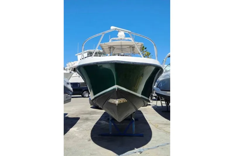 Slide: The Image of Front view of a 2000 SeaVee 290B boat on a stand under clear blue sky. - 4