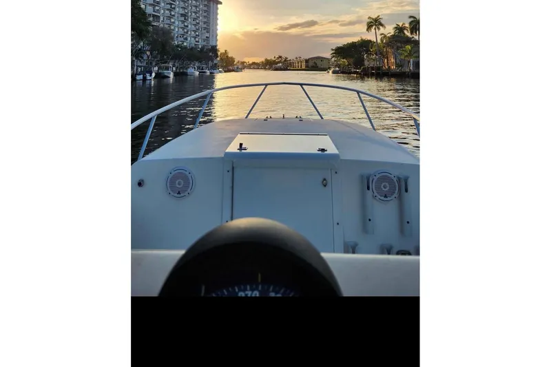 Slide: The Image of SeaVee 290B boat cruising at sunset on a scenic waterway, 2000 model. - 6