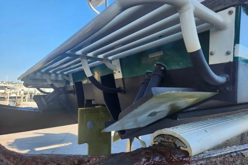 Slide: The Image of Close-up of a 2000 SeaVee 290B boat's underside, showcasing trim tabs and hydraulic components. - 7