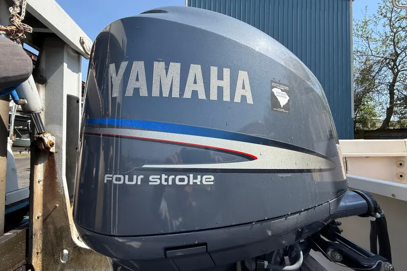 Slide: The Image of Yamaha four-stroke outboard motor on a 2011 Grady-White Fisherman 209 boat. - 11