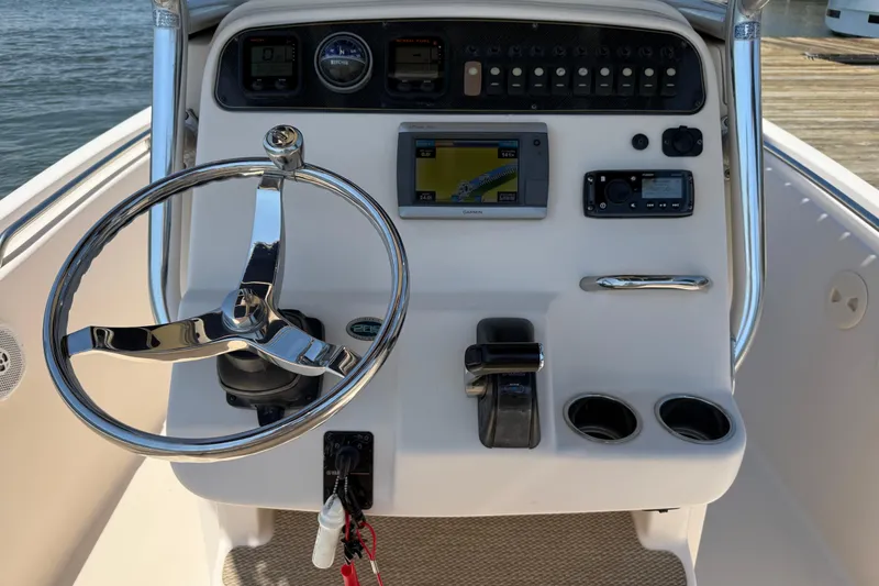 Slide: The Image of 2011 Grady-White Fisherman 209 boat console with steering wheel and navigation controls. - 14