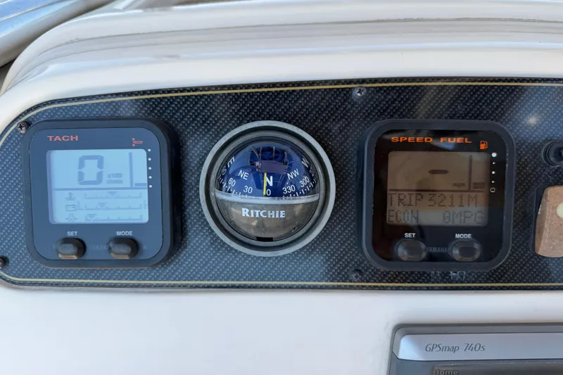 Slide: The Image of Dashboard of a 2011 Grady-White Fisherman 209 with compass and digital gauges. - 16