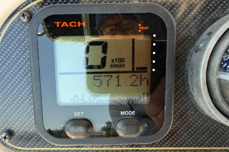Slide: The Image of Tachometer display on 2011 Grady-White Fisherman 209 boat, showing 571.2 hours. - 17