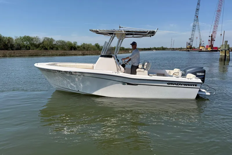 Slide: The Image of 2011 Grady-White Fisherman 209 boat on calm water with Yamaha engine. - 2