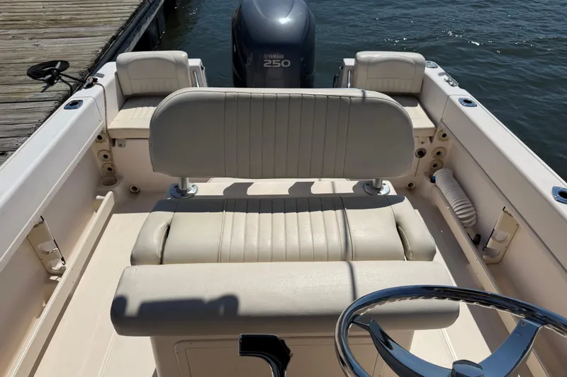 Slide: The Image of 2011 Grady-White Fisherman 209 boat interior with seating and steering wheel. - 23