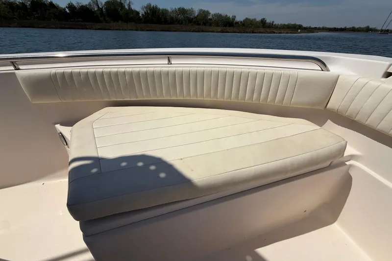 Slide: The Image of 2011 Grady-White Fisherman 209 boat interior with cushioned seating by the water. - 27