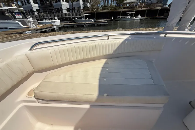 Slide: The Image of 2011 Grady-White Fisherman 209 boat with cushioned seating at a marina. - 28