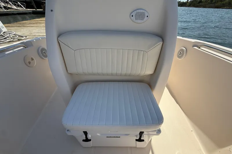 Slide: The Image of 2011 Grady-White Fisherman 209 boat seat with white cushioned upholstery. - 29