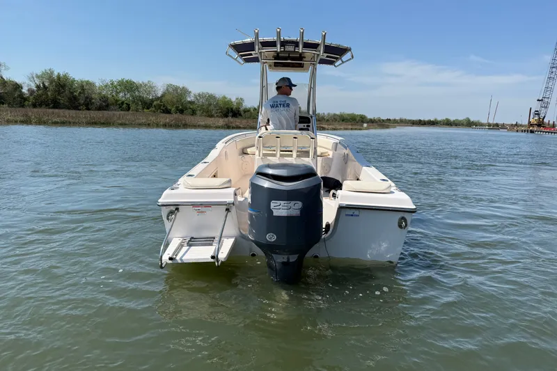 Slide: The Image of 2011 Grady-White Fisherman 209 boat on calm water, rear view with outboard motor. - 5