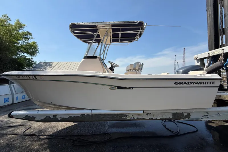 Slide: The Image of 2011 Grady-White Fisherman 209 boat on a lift, under clear blue sky. - 8