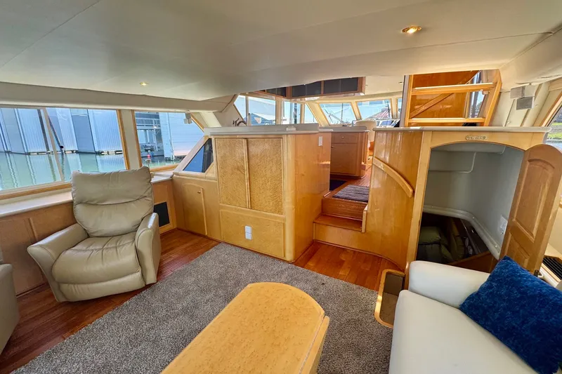 Slide: The Image of Luxurious interior of 2000 Navigator 6300 Classic Pilothouse yacht with plush seating and wood finishes. - 13
