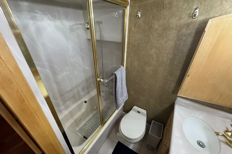Slide: The Image of Bathroom in 2000 Navigator 6300 Classic Pilothouse with shower, toilet, and sink. - 25