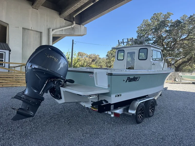 Slide: The Image of 2026 Parker 227 Explorer boat with outboard motor under bridge. - 3