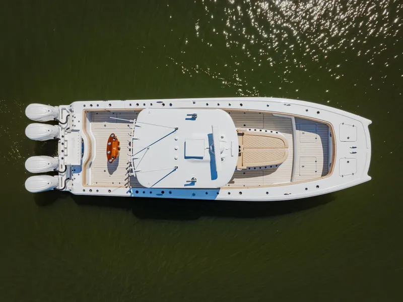 Slide: The Image of Aerial view of 2025 Freeman 38 yacht with triple outboard engines on calm water. - 12