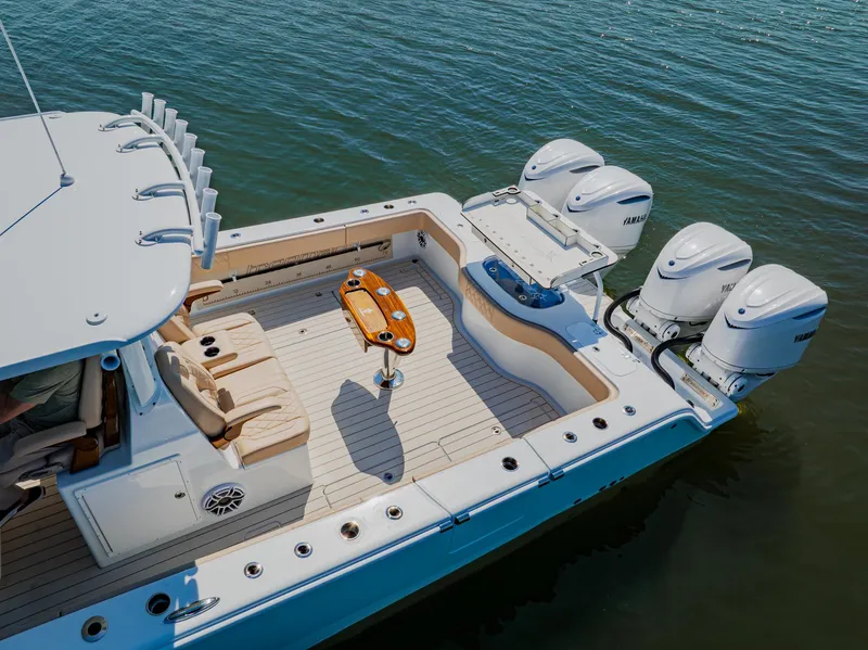 Slide: The Image of Freeman 38 boat, 2025 model, with triple outboard engines on calm water. - 18
