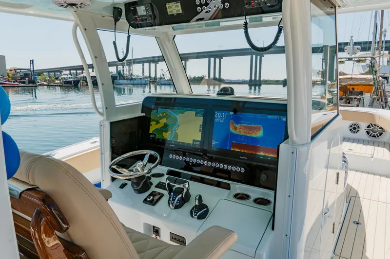 Slide: The Image of Helm of 2025 Freeman 38 boat with advanced navigation displays and controls. - 19