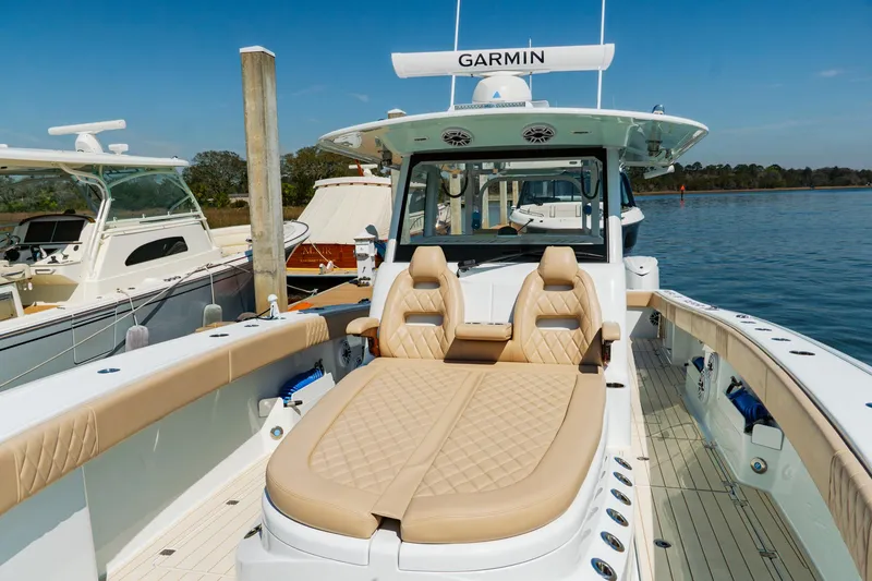 Slide: The Image of Luxury Freeman 38 boat, 2025 model, with tan seating and Garmin equipment, docked by the water. - 29