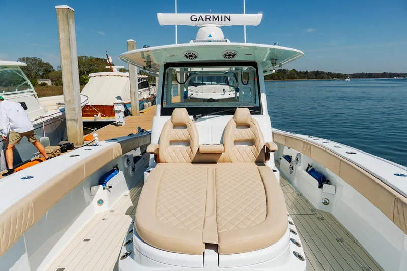 Slide: The Image of Freeman 38 boat, 2025 model, with luxurious seating and Garmin equipment, docked by the water. - 30