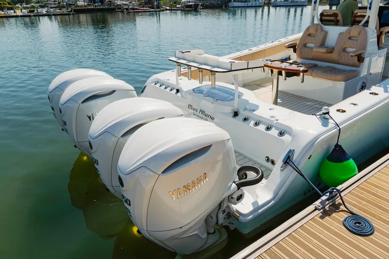 Slide: The Image of Freeman 38 boat with four powerful outboard motors docked at a marina, 2025 model. - 35