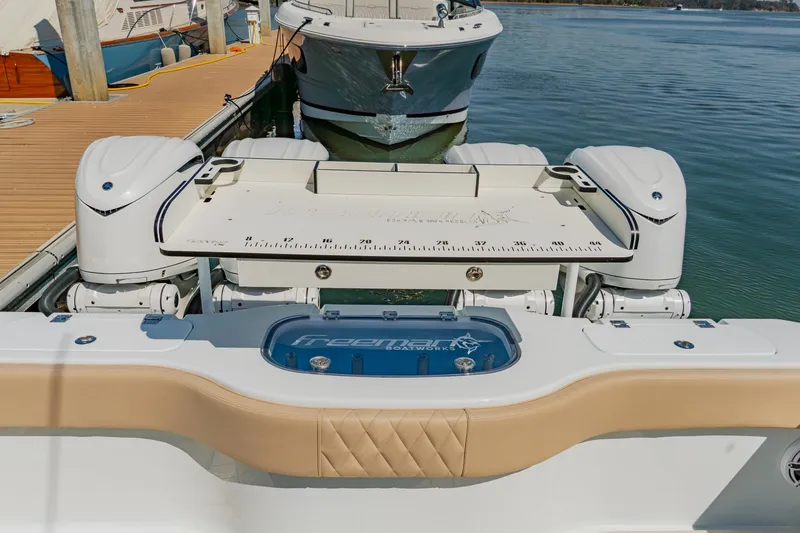 Slide: The Image of Freeman 38 boat stern with dual engines, docked in a marina, 2025 model. - 36