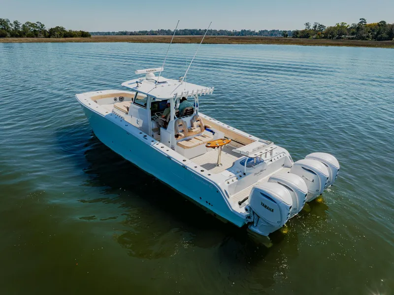 Slide: The Image of Freeman 38 boat, 2025 model, cruising on calm water with triple outboard engines. - 7