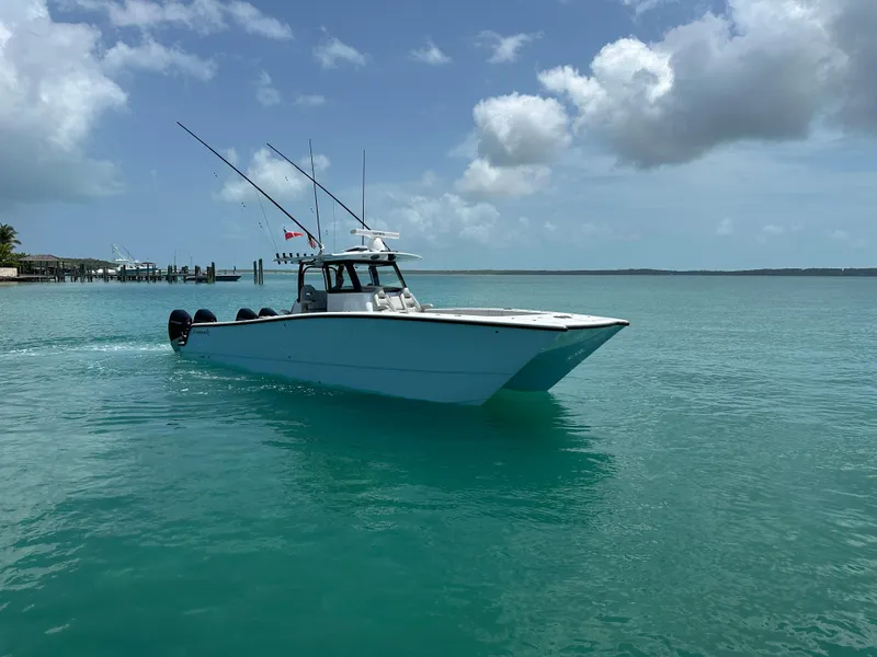 The Image of 2025 Freeman 38 boat cruising on clear turquoise water under a partly cloudy sky. - 0