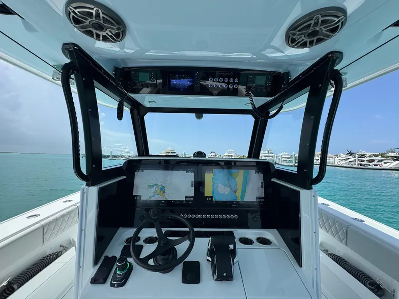 Slide: The Image of Interior view of 2025 Freeman 38 boat cockpit with navigation screens and steering wheel. - 12