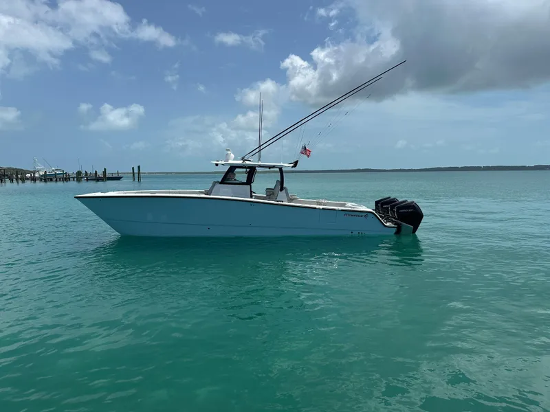 Slide: The Image of 2025 Freeman 38 boat on turquoise water under a partly cloudy sky. - 2