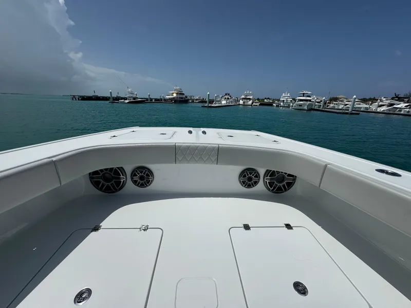 Slide: The Image of Freeman 38 boat deck, 2025 model, docked in a marina with clear blue water. - 20