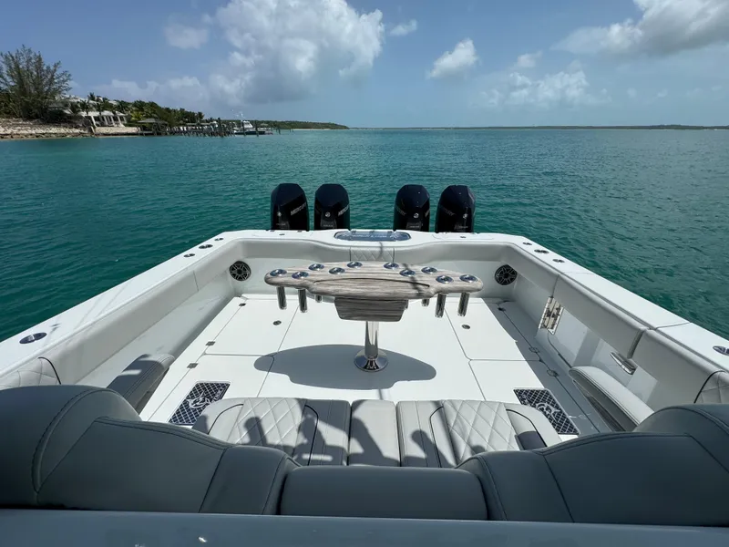 Slide: The Image of Freeman 38 boat, 2025 model, with spacious deck and multiple outboard motors on calm water. - 22