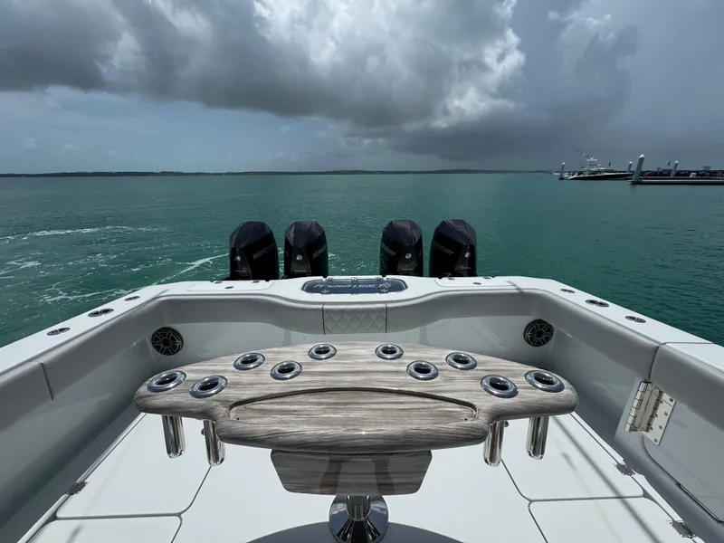 Slide: The Image of 2025 Freeman 38 boat with multiple engines on a calm sea under cloudy skies. - 27