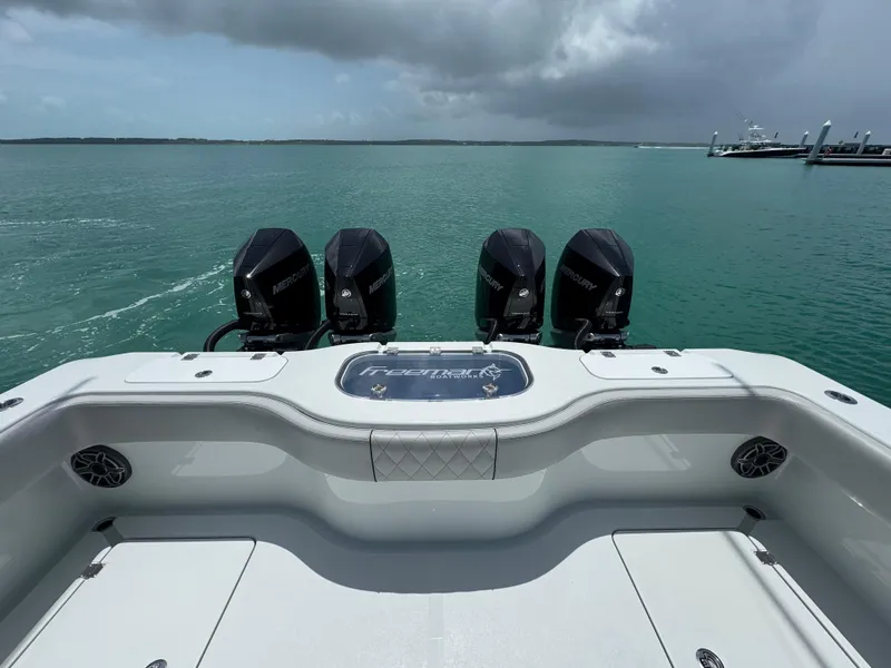 Slide: The Image of Freeman 38 boat with four Mercury engines on calm water, 2025 model. - 28