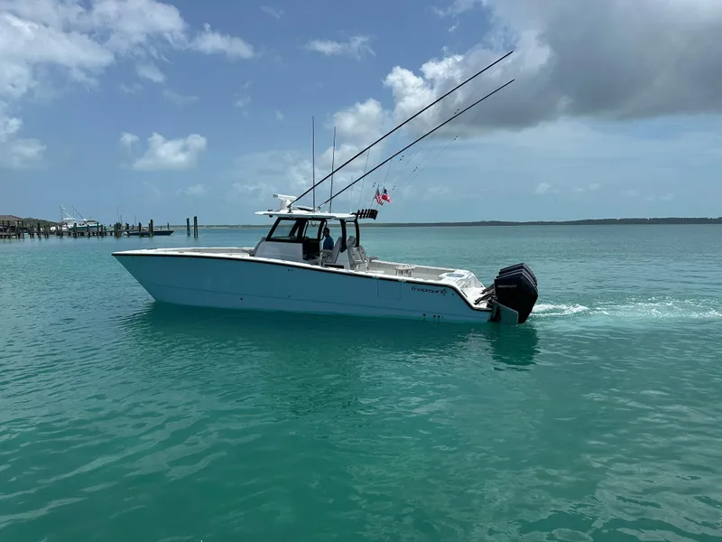 Slide: The Image of 2025 Freeman 38 boat cruising on turquoise water under a partly cloudy sky. - 3