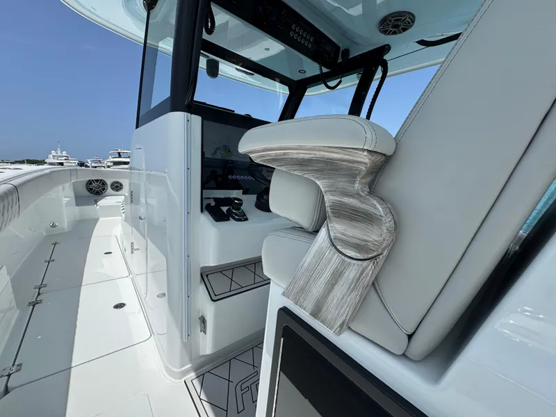 Slide: The Image of Interior of a 2025 Freeman 38 boat, featuring sleek seating and modern controls. - 32