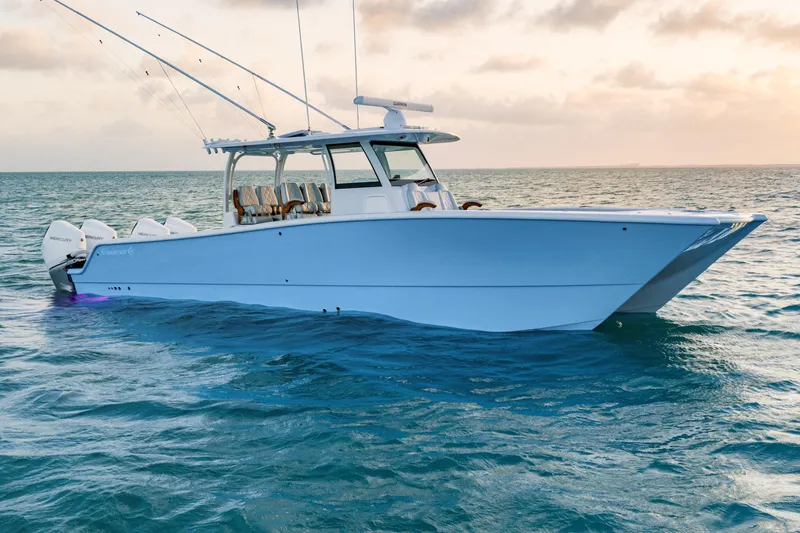 The Image of 2026 Freeman 38 boat on ocean at sunset, featuring multiple outboard engines. - 39