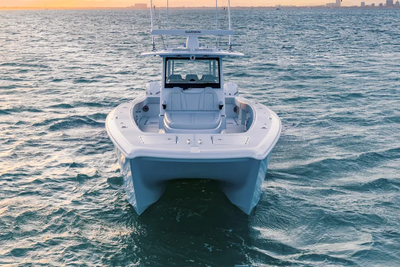 Slide: The Image of 2026 Freeman 38 boat on open water at sunset. - 42