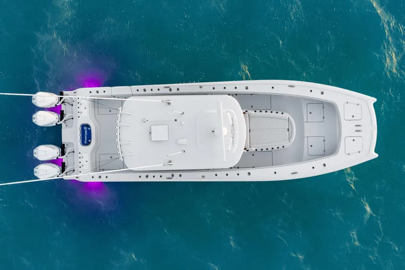 Slide: The Image of Aerial view of 2026 Freeman 38 boat with triple engines on blue water. - 45