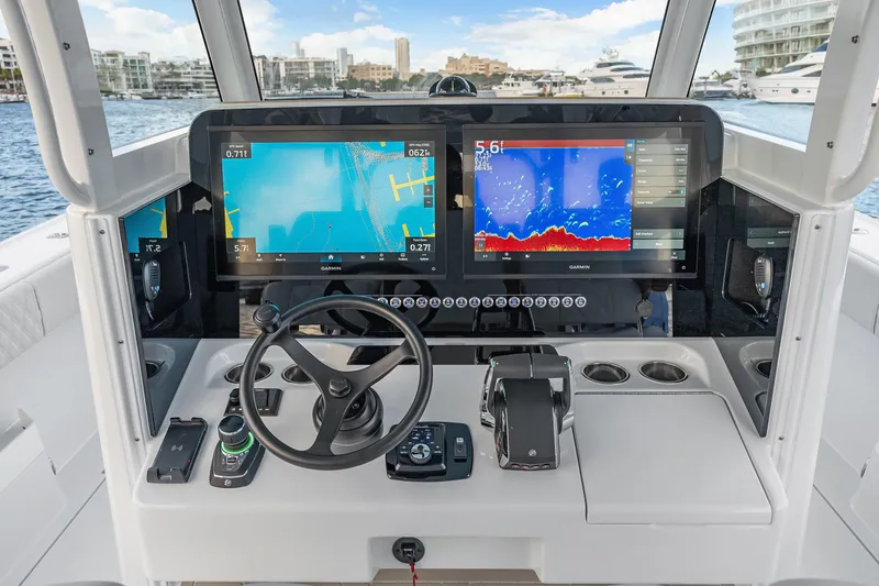 Slide: The Image of Helm of 2026 Freeman 38 boat with advanced navigation displays and controls. - 46